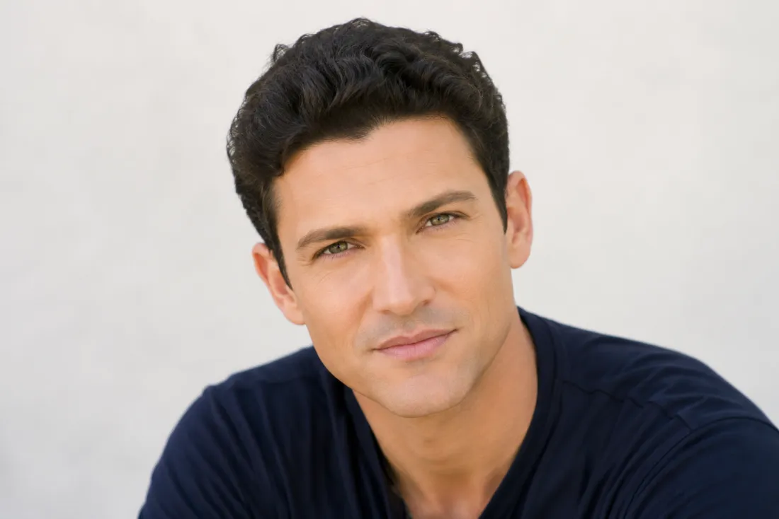 A person shown younger with fuller hair and smoother skin from a single photo