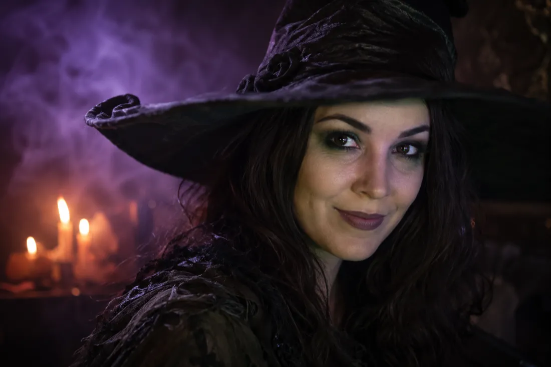 Close-up showing the same recognizable face wearing witch makeup and a pointed hat