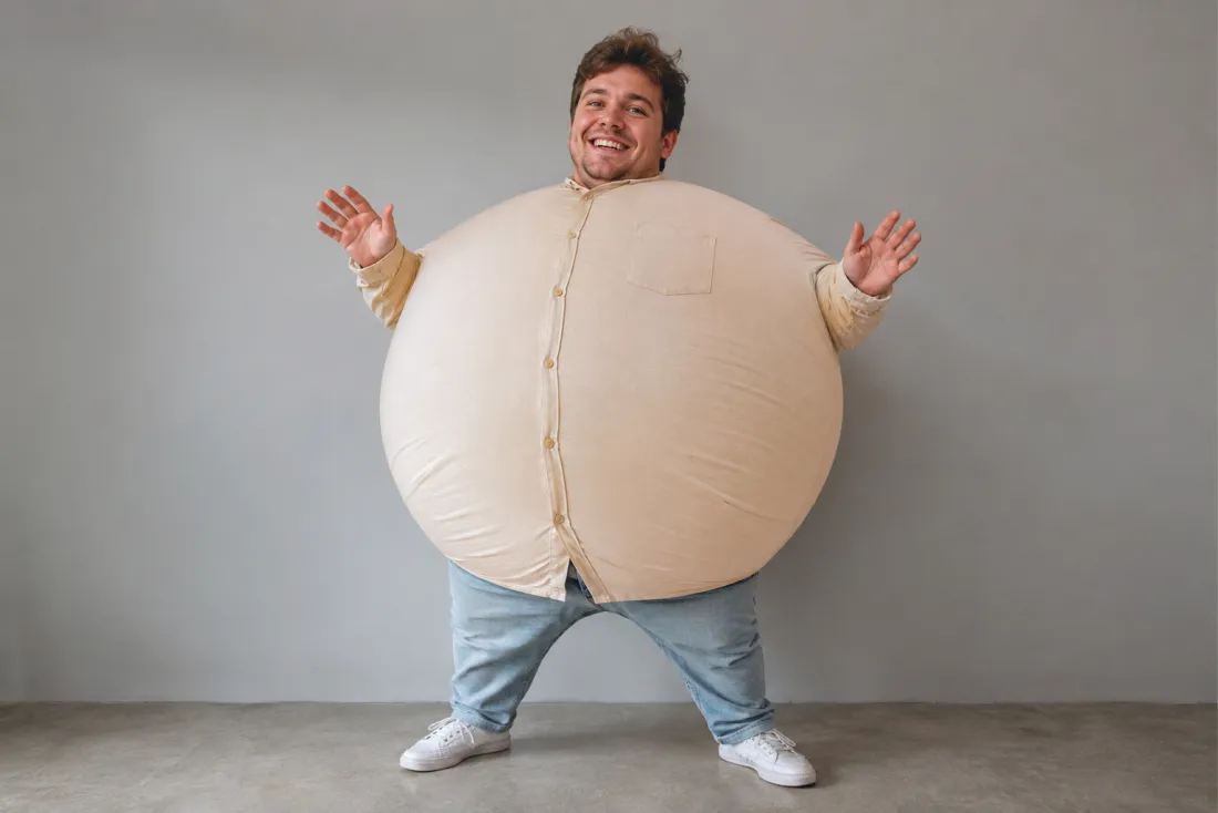 A man's photo mid-inflate, body rounded like a balloon