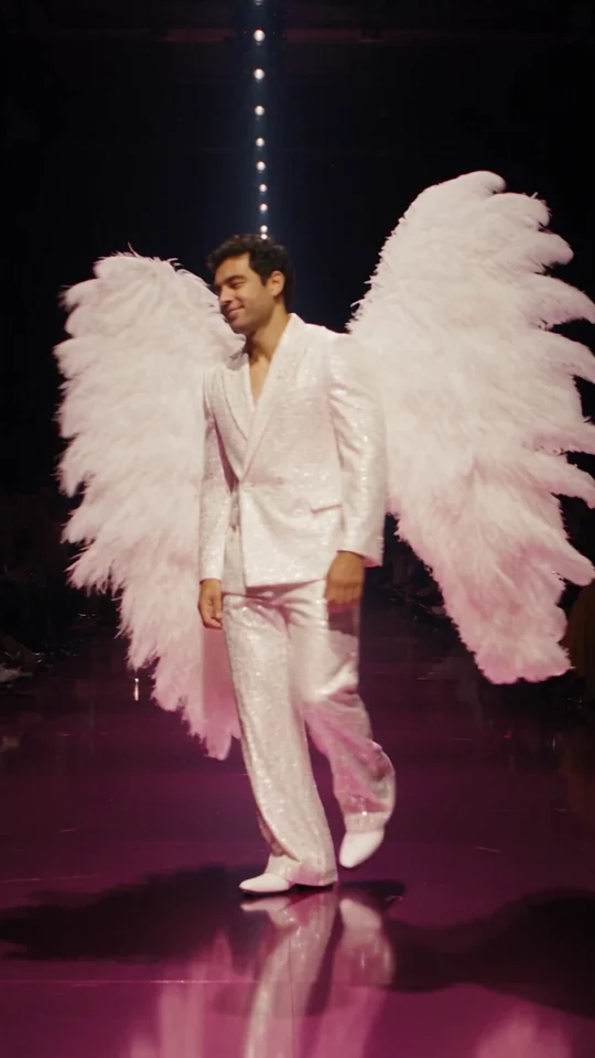 Middle of the generated runway sample, performer turning to show the wings